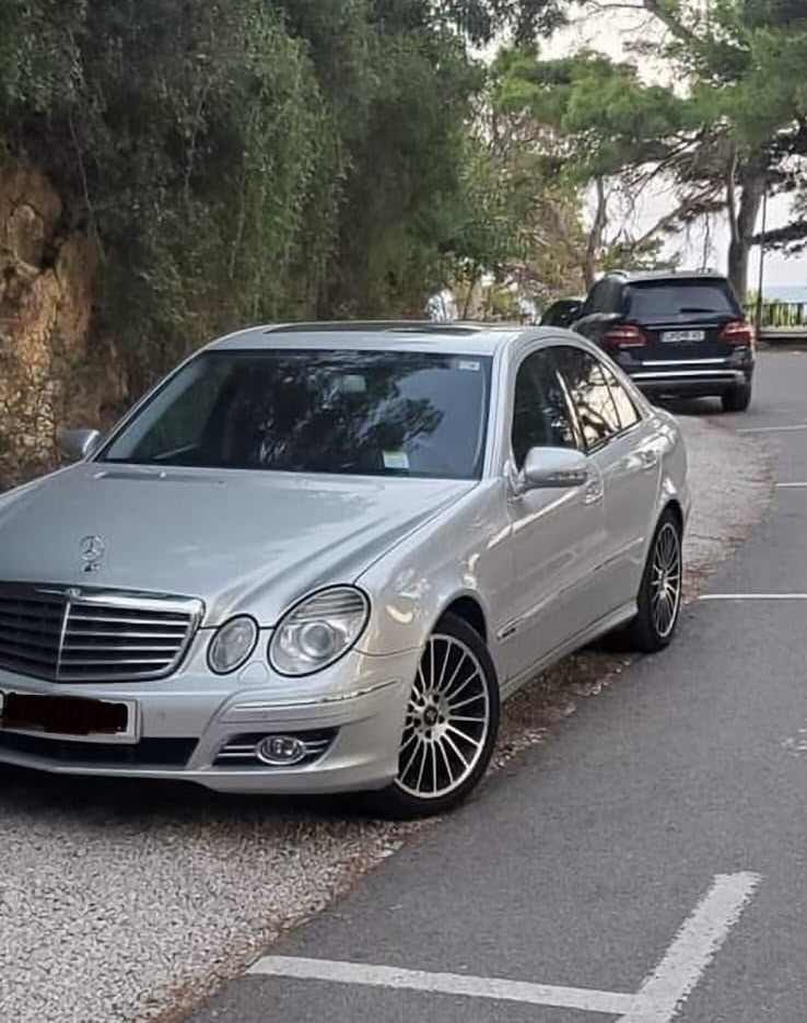 Silver Mercedes-Benz E-Class W211 photographed outdoors from the front in Albania