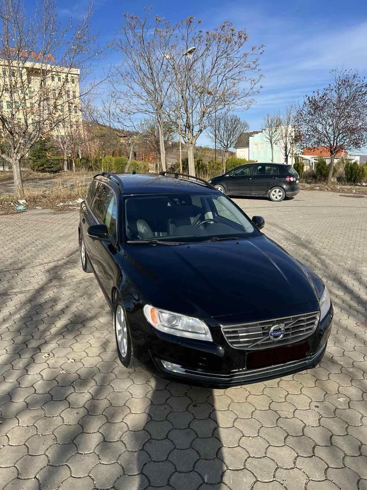 Rear three-quarter view of the dark Volvo V70 2016 estate available for rent in Tirana
