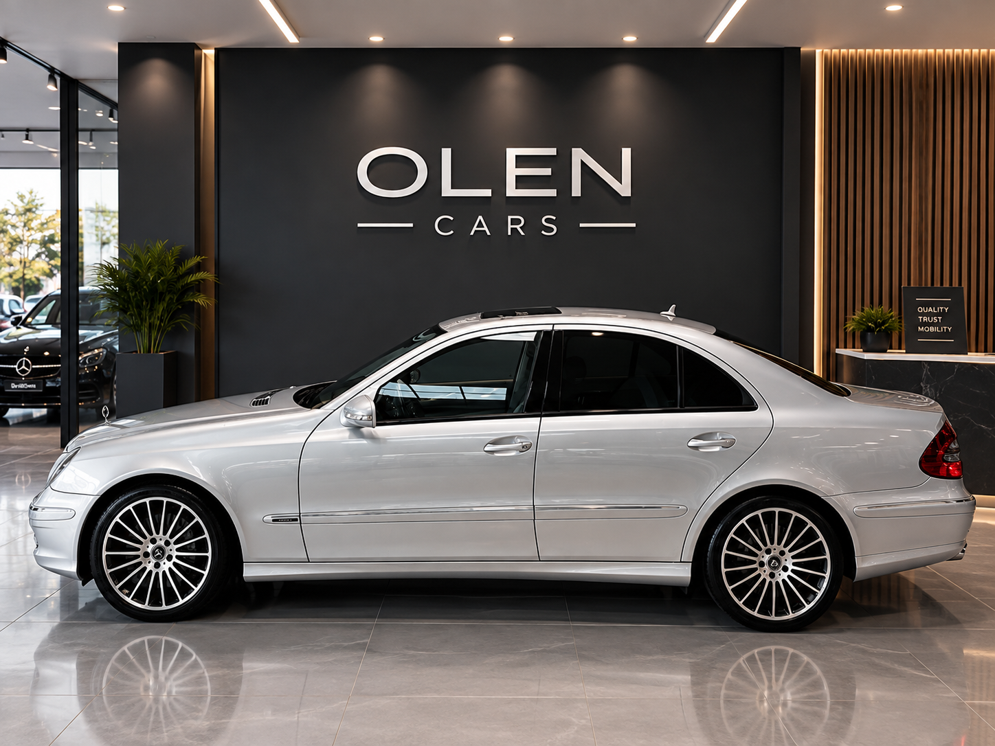 Silver Mercedes-Benz E-Class W211 full side profile in the showroom