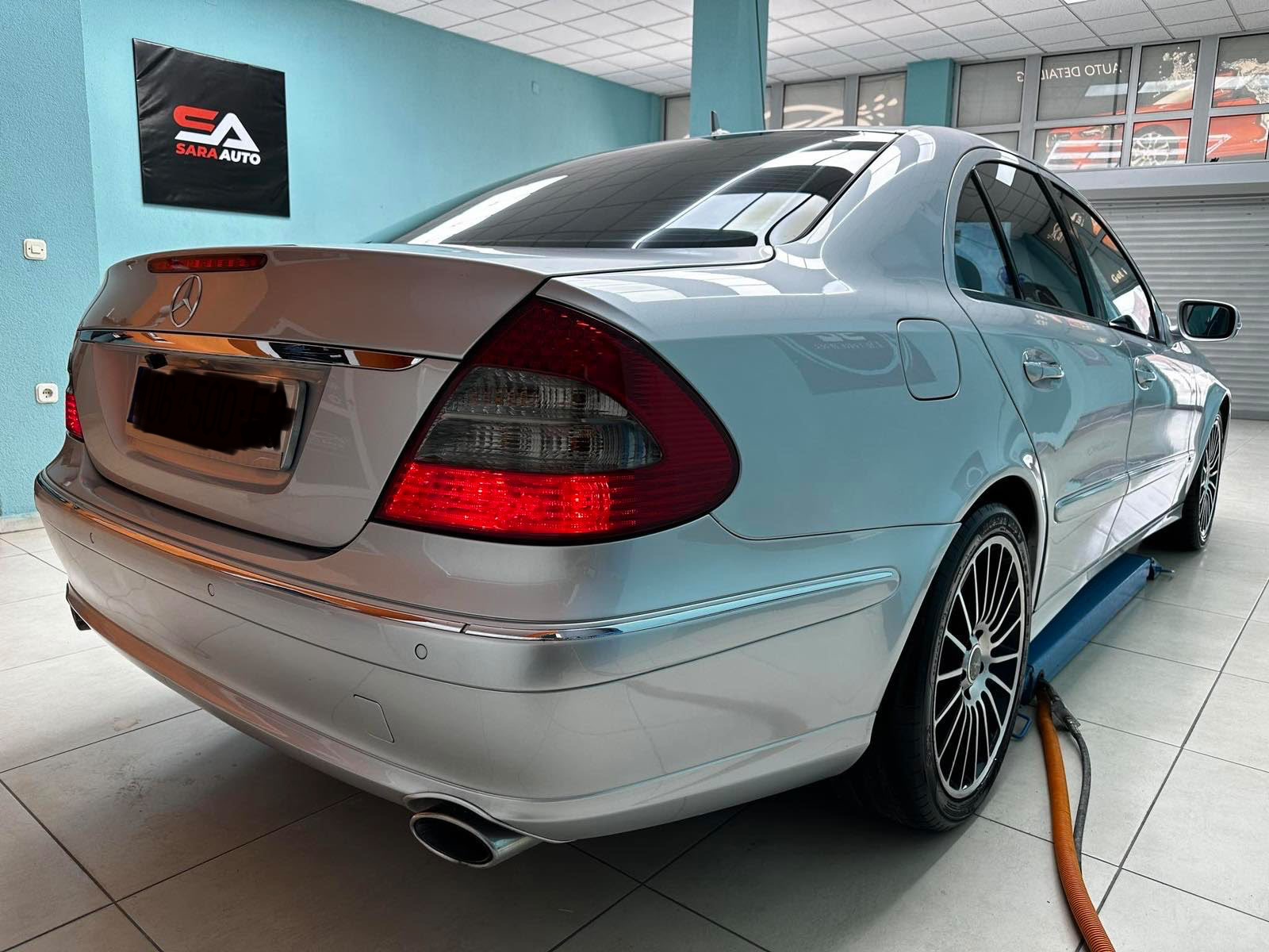 Rear three-quarter view of the silver Mercedes-Benz E-Class W211 rental car
